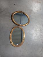 Deux miroirs ovale en bois et stuc doré à décor...