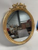 MIROIR ovale en bois stuqué et doré à décor de...