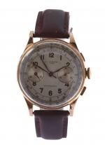 MONTRE en or 750/°° et acier doré, chronographe suisse. Bracelet...