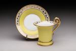 SEVRES. Tasse et soucoupe en porcelaine sur fond jaune et...